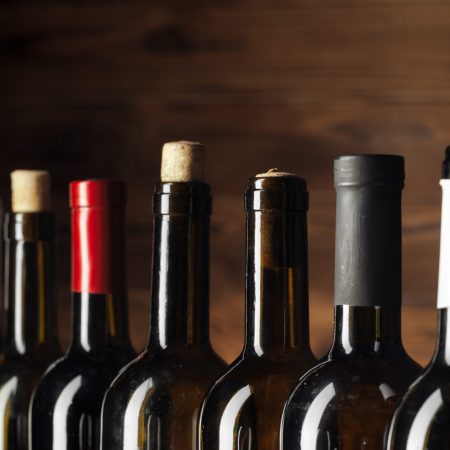 bottle of wine over wooden background